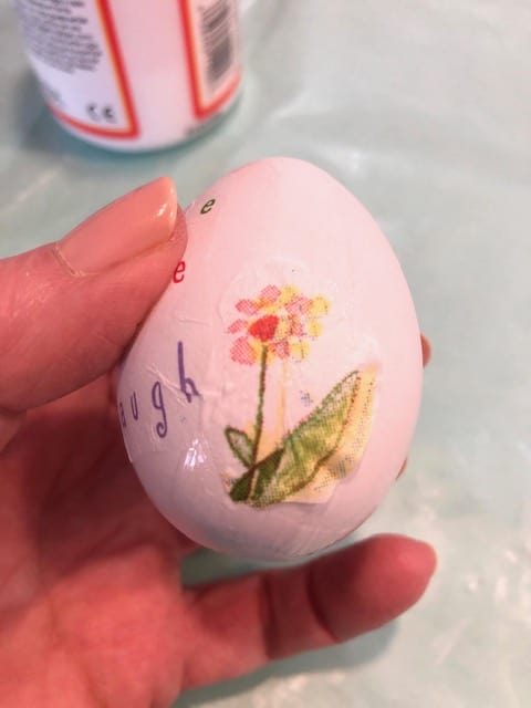 Small flower glued on side of egg
